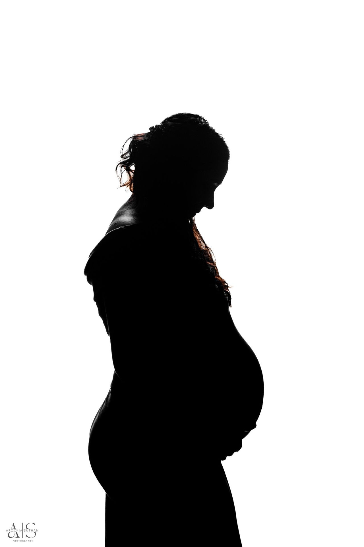 Silhouette of a pregnant woman in profile view against a white background.